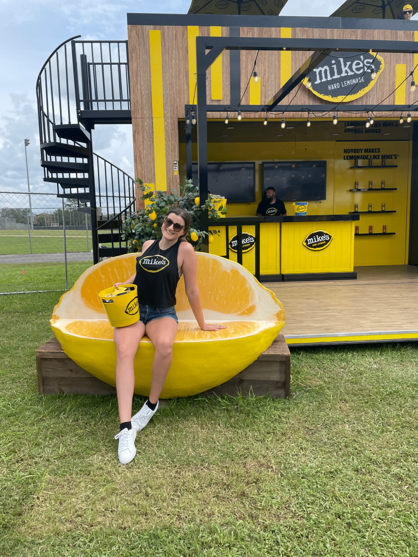 Mike's Hard Lemonade festival activation booth with brand ambassador